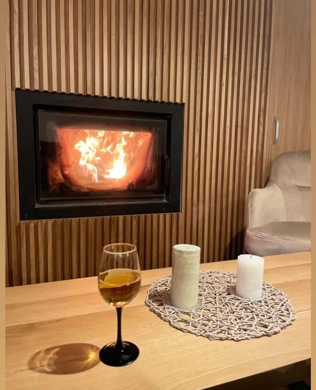 Warm fireplace ambiance with mountain views at Rodnei Retreat Maramureș